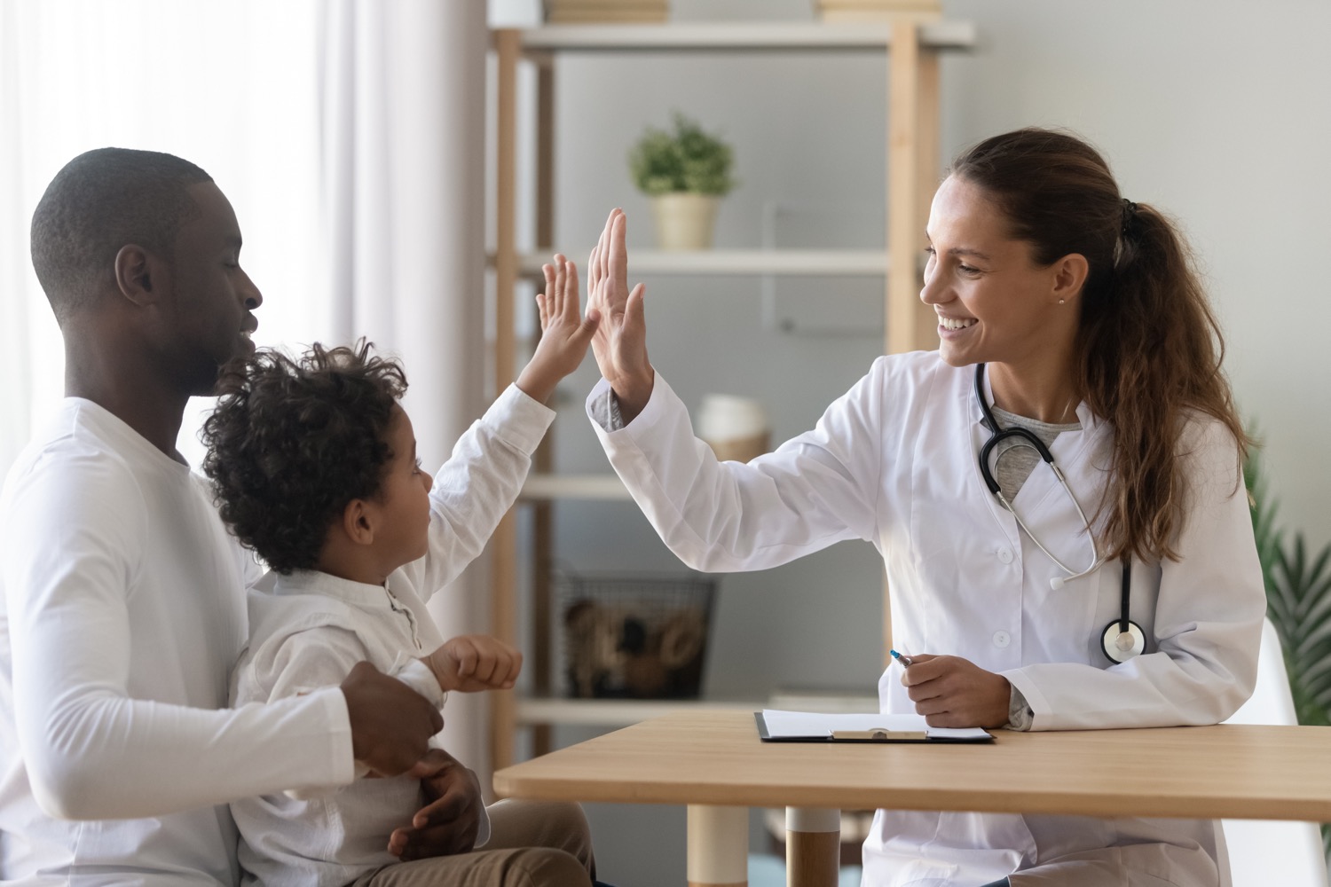 A pediatrician giving a young child a checkup