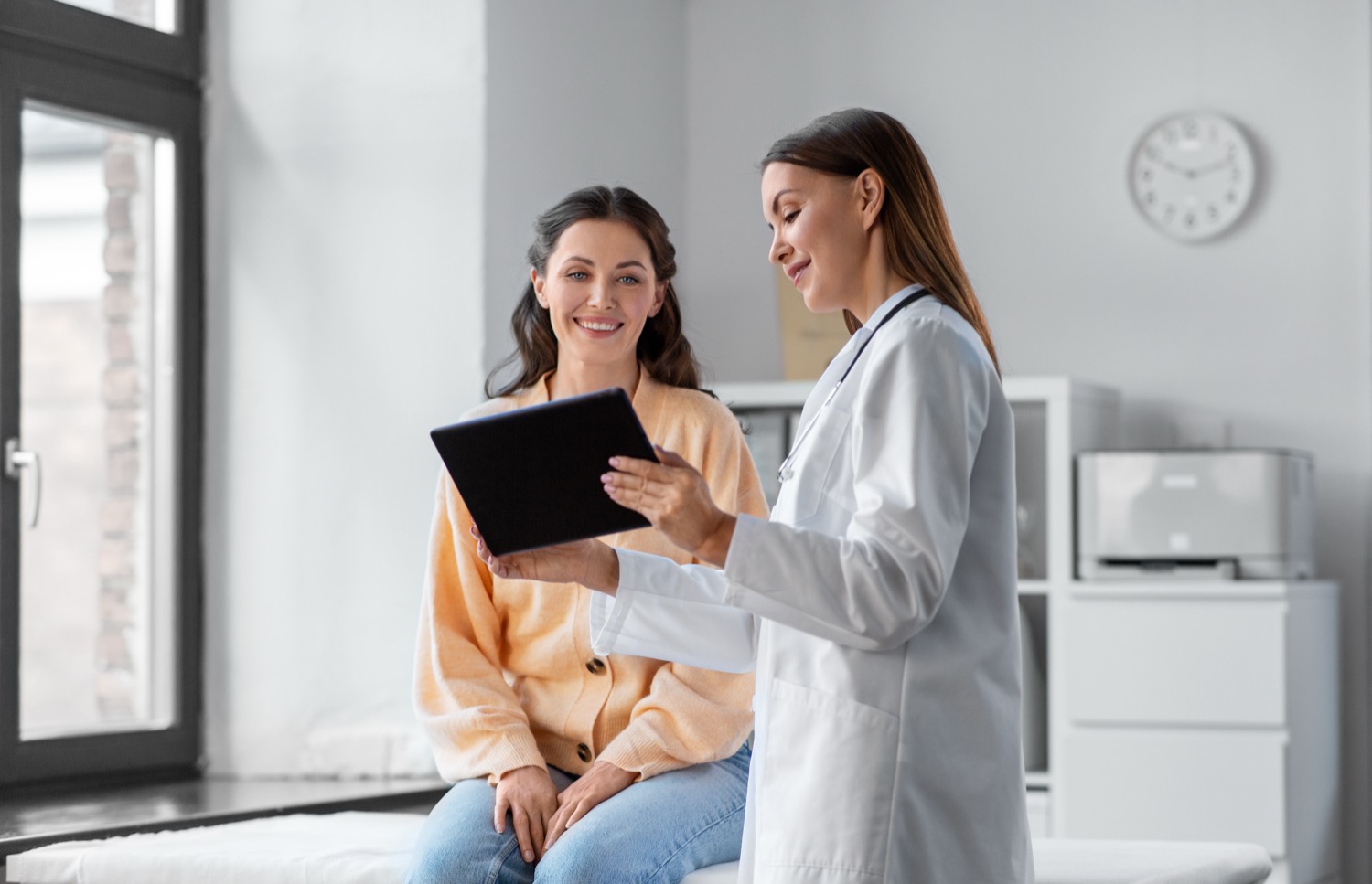 Clear aligner tray held during a consultation