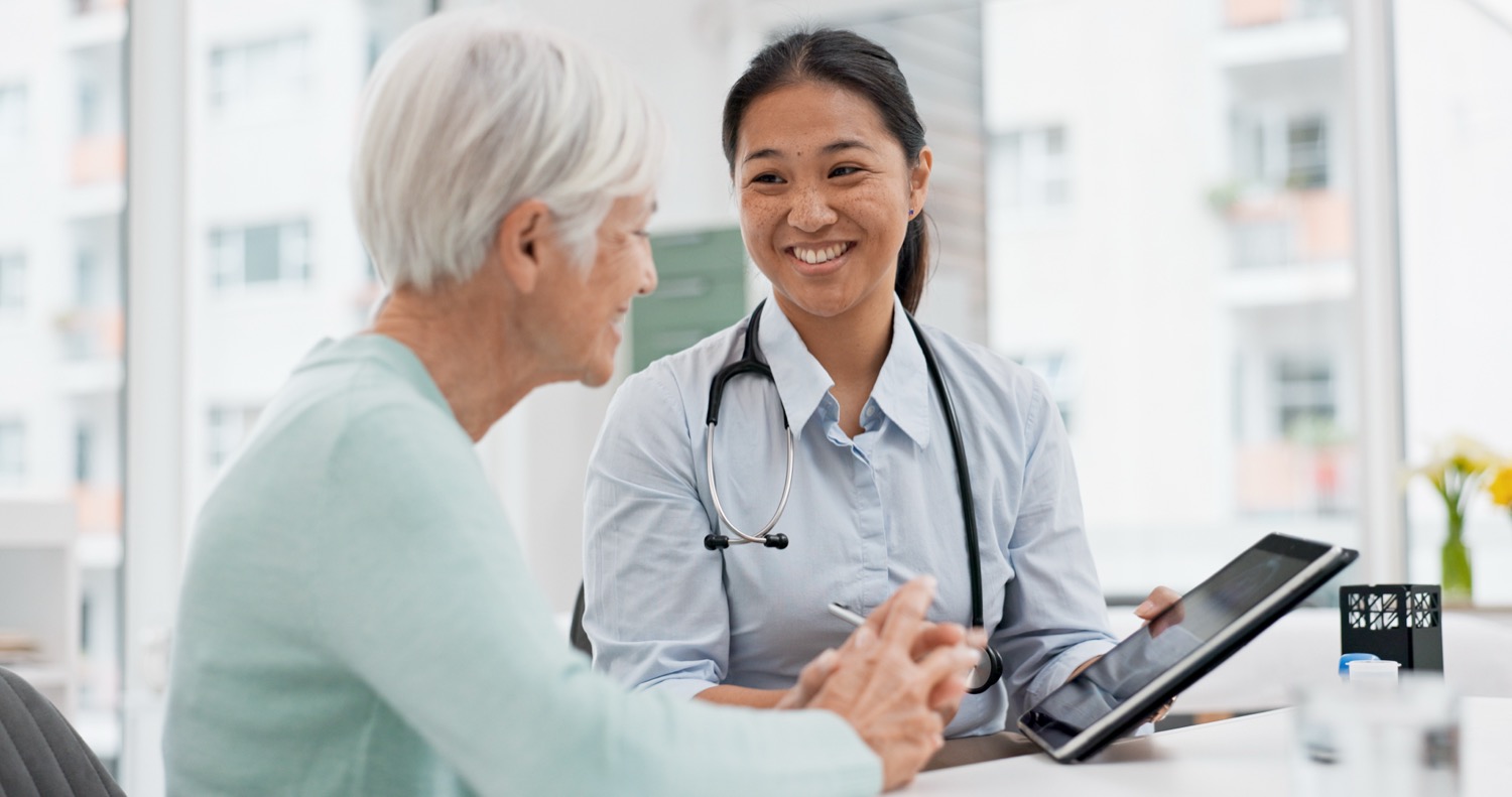 A Riverside provider warmly consulting with a senior patient